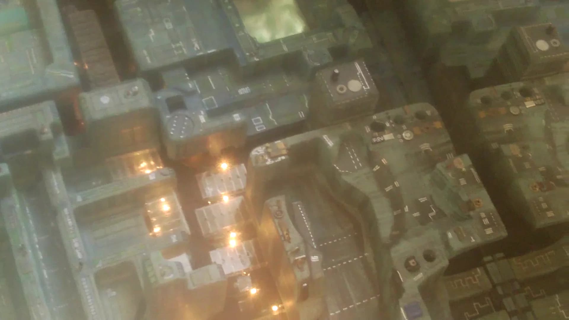 The glowing towers and industrial structures of Meccasphere, a miniature city from the film.