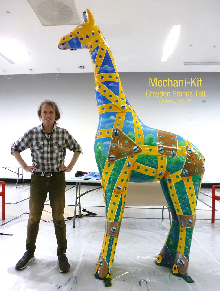Peter Poole standing beside Mechani-Kit in the studio, finished June 2023 for Croydon Stands Tall.